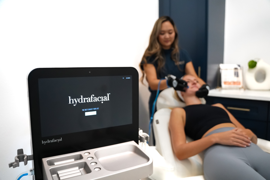 Young woman getting Hydrafacial treatment by Expert at Roots Wellness and Medspa in Tampa, Florida.