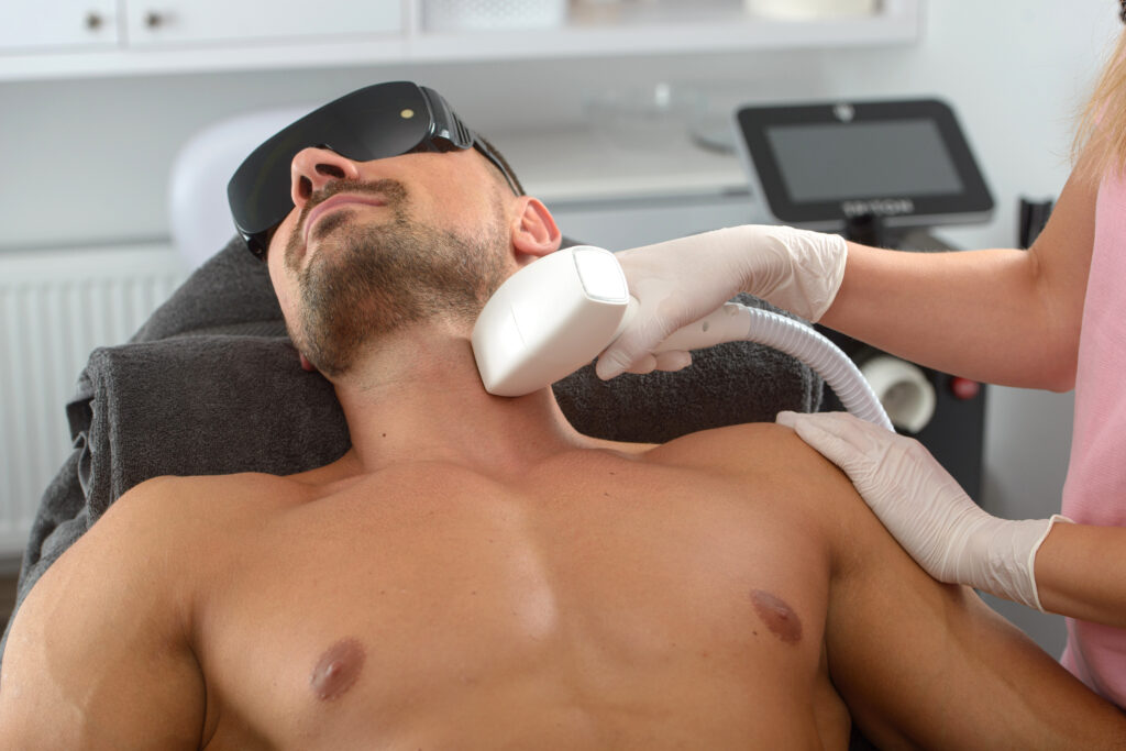 Man with muscular body getting Laser hair removal treatment | Get Laser hair removal at Roots Wellness and Medspa in Tampa, Florida