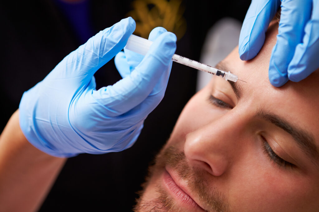 Doctor treating Man with Botox Injection | Get Botox treatment at Roots Wellness and Medspa in Tampa, Florida